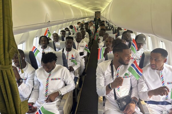 The Gambia national soccer team aboard a plane in Banjul, Gambia, Wednesday, Jan. 10, 2024. A plane carrying Gambia's national soccer team made an emergency landing after a sudden loss of oxygen during their flight to compete in the Africa Cup of Nations tournament. A chartered flight Wednesday carrying the “Scorpions” returned to Gambia's capital Banjul after being airborne for nine minutes when the crew realized there were technical problems, Gambia's Football Federation said in a statement on Facebook. (Gambia Football Federation via AP)