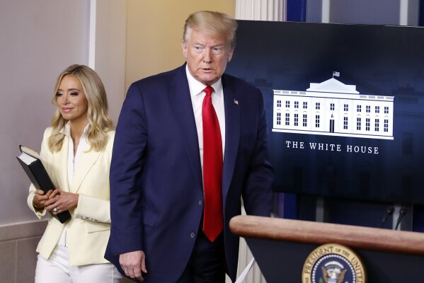 President Donald Trump arrives to speak with reporters about the coronavirus in the James Brady Briefing Room of the White House, Friday, May 22, 2020, in Washington with White House press secretary Kayleigh McEnany. (AP Photo/Alex Brandon)