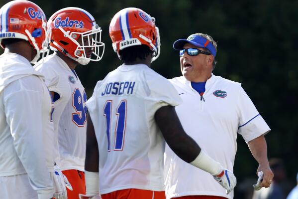 FILE - In this March 16, 2018, file photo, Florida defensive coordinator Todd Grantham works with some of the defense during NCAA college football practice in Gainesville, Fla.  The 13th-ranked Gators get a chance to show how much they’ve improved. Florida opens the season Saturday night against Florida Atlantic. (Brad McClenny/Ocala Star-Banner via AP)