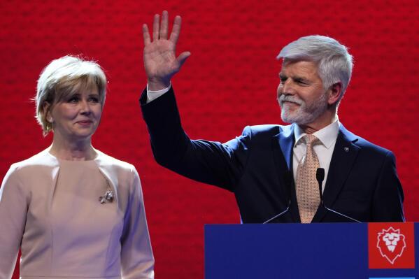 Czech Republic's President elect Petr Pavel with his wife Eva greets his supporters after announcement of the preliminary results of the presidential runoff in Prague, Czech Republic, Saturday, Jan. 28, 2023. (AP Photo/Petr David Josek)