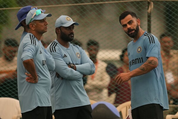 India's Virat Kohli chats with head coach Rahul David, left, during a practice session ahead of the third one-day international cricket match against Australia in Rajkot, India, Tuesday, Sept. 26, 2023. (AP Photo/Ajit Solanki)