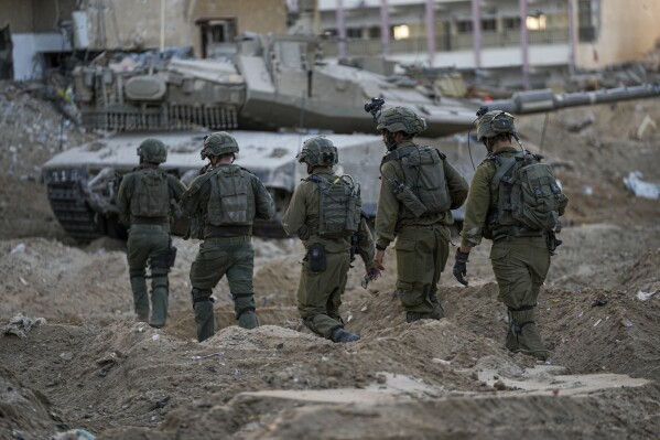 Israeli soldiers are seen during a ground operation in the Gaza Strip, Wednesday, Nov. 8, 2023. (AP Photo/Ohad Zwigenberg)