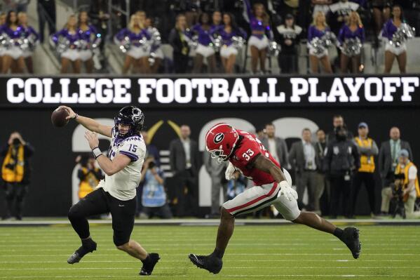 FILE - TCU quarterback Max Duggan (15) runs out of the pocket against Georgia linebacker Robert Beal Jr. (33) during the second half of the national championship NCAA College Football Playoff game, Monday, Jan. 9, 2023, in Inglewood, Calif. The first-round games of the inaugural 12-team College Football Playoff will be played on Friday night and Saturday of the third week of December 2024, and the semifinals will be played in early January on weeknights to avoid conflicting with the NFL playoffs, CFP executive director Bill Hancock confirmed on Thursday, April 27, 2023. (AP Photo/Mark J. Terrill, FIle)