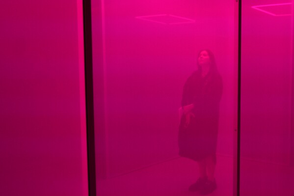 A woman visits "Making Sense of Color", a Google Design Studio exhibition in Milan, Italy, April 15, 2024. (AP Photo/Antonio Calanni)