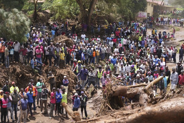 FILE - People gather on a bridge after floodwater washed away houses near Nakuru, Kenya, Tuesday, April 30, 2024. (AP Photo/Brian Inganga, file)