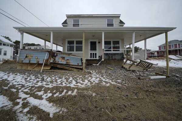 FILE - A roof is temporarily stabilized, Wednesday, Jan. 31, 2024, in the Camp Ellis neighborhood of Saco, Maine. A powerful coastal storm washed away most of the home's wrap-around porch. (AP Photo/Robert F. Bukaty)