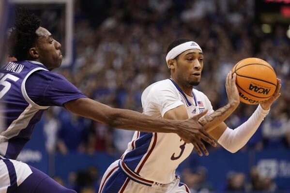 Kansas guard Dajuan Harris Jr. (3) passes under pressure from Kansas State forward Nae'Qwan Tomlin, left, during the first half of an NCAA college basketball game Tuesday, Jan. 31, 2023, in Lawrence, Kan. (AP Photo/Charlie Riedel)