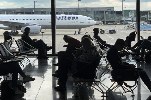FILE -Passengers wait for their Lufthansa flight at the airport in Frankfurt, Germany, Saturday, May 15, 2021. The number of air passengers in Germany rebounded somewhat in 2021, but was still over two-thirds below pre-pandemic levels, official figures showed Monday. (AP Photo/Martin Meissner,file)