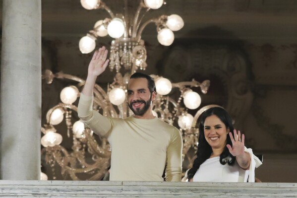 El Salvador President Nayib Bukele, left, accompanied by his wife Gabriela Rodriguez, wave to supporters from the balcony of the presidential palace in San Salvador, El Salvador, after polls closed for general elections on Sunday, Feb. 4, 2024. El Salvador President Bukele and his New Ideas party have won the supermajority the leader needs in Congress to govern as he pleases, electoral officials announced Monday, Feb. 19. (AP Photo/Salvador Melendez, File)