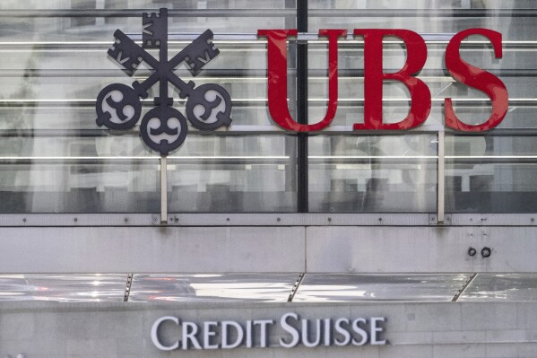 FILE - The logos of the Swiss banks Credit Suisse and UBS are pictured in Zurich, Switzerland, June 12, 2023. UBS said Friday, Aug. 11, 2023, it has shut down rescue packages agreed with Swiss authorities that made available up to 200 billion Swiss francs (about $230 billion) to help shepherd through its takeover of ailing rival Credit Suisse and avert an international banking crisis. (Ennio Leanza/Keystone via AP, File)