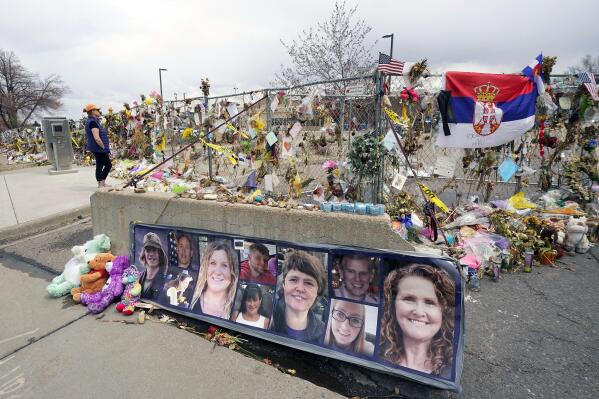 FILE - Pictures of the 10 victims of a mass shooting in a King Soopers grocery store are posted on a cement barrier outside the supermarket in Boulder, Colo., on April 23, 2021. More relatives of people shot to death at a Colorado supermarket in 2021 are suing gun-maker Sturm, Ruger & Co. over how it marketed the firearm used in the massacre, adding to litigation first filed earlier this month against the company. (AP Photo/David Zalubowski, File)