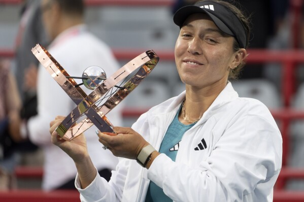 Jessica Pegula, of the United States, holds the trophy following her win over Liudmila Samsonova, of Russia, in the final of the women's National Bank Open tennis tournament in Montreal, Sunday, Aug. 13, 2023. (Christinne Muschi/The Canadian Press via AP)
