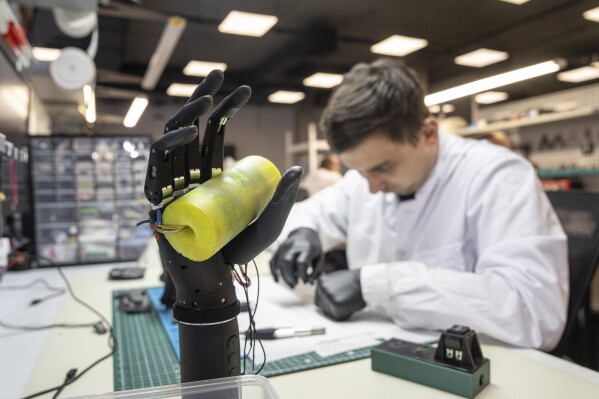 Engineer Oleksandr collects bionic prostheses for Ukrainian soldiers at the Esper Bionics office in Kyiv, Ukraine, Tuesday, Oct. 31, 2023. (AP Photo/Evgeniy Maloletka)