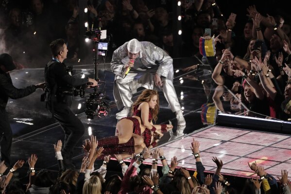 Shakira performs with Bad Bunny during halftime of the NFL Super Bowl 54 football game Sunday, Feb. 2, 2020, in Miami Gardens, Fla. (AP Photo/Charlie Riedel)