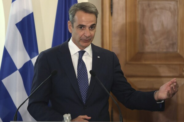 Greek Prime Minister Kyriakos Mitsotakis addresses the media, during a press conference with Cyprus' President Nikos Christodoulide after their meeting at the Presidential Palace in Nicosia, Cyprus, on Monday, July 31, 2023. Mitsotakis is in Cyprus on an official visit. (Yiannis Kourtoglou Pool via AP)