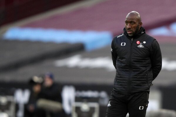 FILE - In this Saturday, Jan. 23, 2021 file photo, Darren Moore looks on during the English FA Cup fourth round soccer match between West Ham United and Doncaster Rovers at the London Stadium in London. Sheffield Wednesday manager Darren Moore says he has developed pneumonia and blood clots on his lungs following a recent coronavirus infection. The 46-year-old Moore returned from the requisite COVID-19 isolation period on Monday, April 12 but felt discomfort the next night following the Owls’ 2-0 loss to Swansea. (AP Photo/Ian Walton, file)