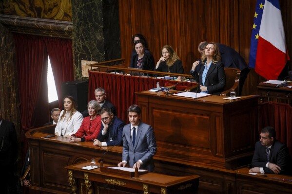 French Prime Minister Gabriel Attal, center, speaks during the Congress of both Houses of Parliament at the Palace of Versailles as President of the National Assembly Yael Braun-Pivet sits behind him in Versailles, west of Paris, Monday, March 4, 2024. French lawmakers gather at the Palace of Versailles for a historic vote that will make abortion a constitutional right. (AP Photo/Thomas Padilla)