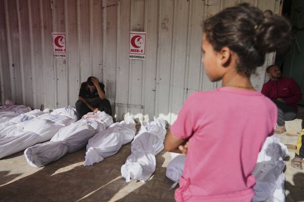 Palestinians mourn their relatives killed in an Israeli airstrikes in Jabalia, northern Gaza Strip, on Wednesday, May 14, 2025. According to local hospitals, 48 people were killed in the strikes, including 22 children. (AP Photo/Jehad Alshrafi)