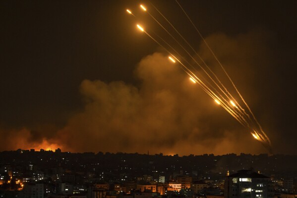 Rockets are fired toward Israel from the Gaza Strip, Sunday, Oct. 8, 2023.. (AP Photo/Fatima Shbair)