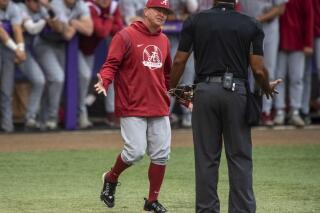 Alabama head coach Brad Bohannon, left, argues with umpire Joe Harris after being tossed from an NCAA college baseball game in the bottom of the second inning against LSU, Saturday, April 29, 2023, in Baton Rouge, La. Alabama is firing baseball coach Brad Bohannon after a report of suspicious bets involving his team, with the school saying he violated “the standards, duties and responsibilities expected of university employees.” The firing announced Thursday, May 4, came three days after a report warning of suspicious wagers prompted Ohio’s top gambling regulator to bar licensed sportsbooks in the state from accepting bets on Alabama baseball games. (Michael Johnson/The Advocate via AP)