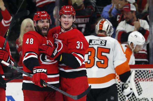 Carolina Hurricanes' Jordan Martinook (48) is congratulated on his goal by teammate Andrei Svechnikov (37) during the third period of an NHL hockey game against the Philadelphia Flyers in Raleigh, N.C., Saturday, March 12, 2022. (AP Photo/Karl B DeBlaker)