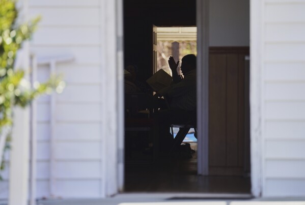 Rodney Ivey keeps time while singing from the tenor section at a Sacred Harp singing event at Holly Springs Primitive Baptist Church in Bremen, Ga., on Sunday, March 23, 2025. (AP Photo/Jessie Wardarski)