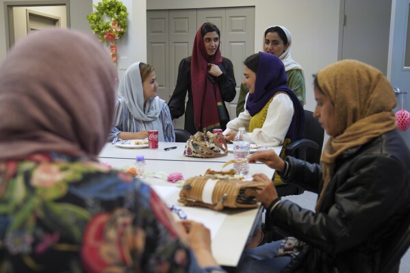 A group of female Afghan refugees gather for a class on self-care and a post-Ramadan celebration at Catholic Charities Migrant and Refugee Services office in Fredericksburg, Va., on Tuesday, April 8, 2025. (AP Photo/Jessie Wardarski)