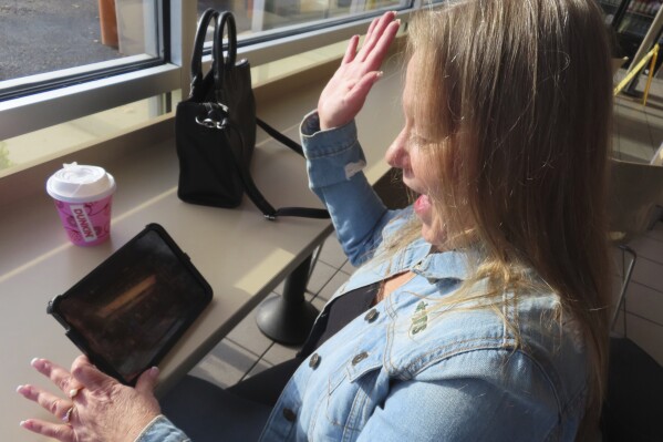 Elaine Vallaster reacts to a winning spin while playing an internet slots game on her tablet in Hazlet, N.J. on Nov. 24, 2023. Figures released on Tuesday, Feb. 20, 2024, by the American Gaming Association show that the U.S. commercial casino industry had its best year ever in 2023, winning $66.5 billion from gamblers. When figures from tribal casinos are tallied later this year, the combined total is expected to approach $110 billion for 2023. (AP Photo/Wayne Parry)