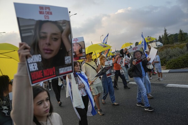Families and friends of about 240 hostages held by Hamas in Gaza call for their return during a five-day "March for the Hostages" from Tel Aviv to the Prime Minister's Office in Jerusalem, near the town of Abu Ghosh, Israel, Friday, Nov. 17, 2023. (AP Photo/Ohad Zwigenberg)