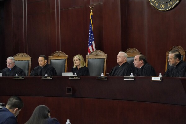 FILE - Arizona Supreme Court Justices from left; William G. Montgomery, John R Lopez IV, Vice Chief Justice Ann A. Scott Timmer, Chief Justice Robert M. Brutinel, Clint Bolick and James Beene listen to oral arguments on April 20, 2021, in Phoenix. The Arizona Supreme Court ruled Tuesday, April 9, 2024, that the state can enforce its long-dormant law criminalizing all abortions except when a mother’s life is at stake. (AP Photo/Matt York, File)
