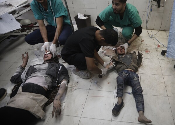 Palestinians wounded in the Israeli bombardment of the Gaza Strip receive treatment at the Nasser hospital in Khan Younis, Southern Gaza Strip, Sunday, Dec. 31, 2023. (AP Photo/Mohammed Dahman)