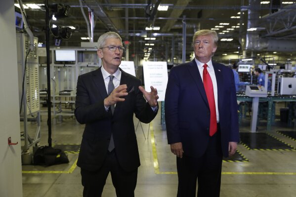 Apple CEO Tim Cook and President Donald Trump speak during a tour of an Apple manufacturing plant, Wednesday, Nov. 20, 2019, in Austin. (AP Photo/ Evan Vucci)