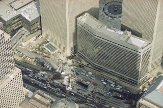 Manhattan's West Street is jammed with police and emergency service vehicles in the aftermath of yesterday's explosion that rocked New York's World Trade Center's twin towers and the Vista Hotel, foreground right, Feb. 27, 1993, causing evacuation of the financial center. Officials all but confirmed that a bomb caused the huge blast that left at least five people dead and injured hundreds. (AP Photo/Mike Derer)