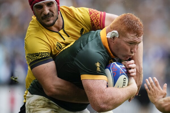 South Africa's Steven Kitshoff, right, is tackled by Romania's Adrian Motoc during the Rugby World Cup Pool B match between South Africa and Romania at the Stade de Bordeaux in Bordeaux, France, Sunday, Sept. 17, 2023. (AP Photo/Christophe Ena)