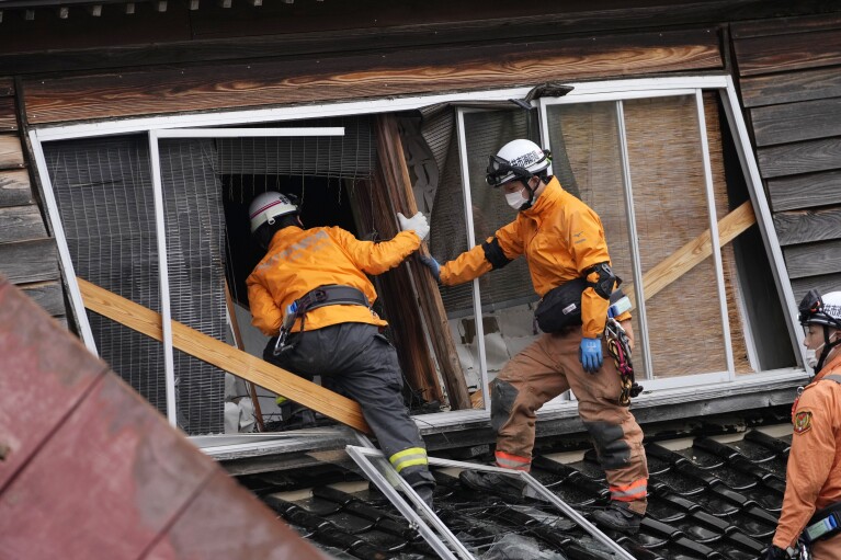 Rescue workers search a collapsed house caused by powerful earthquake in Suzu, Ishikawa Prefecture Wednesday, Jan. 3, 2024.(AP Photo/Hiro Komae)