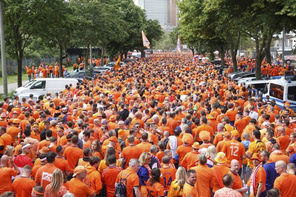 Netherlands fans walk to the stadium for the Group D match between Poland and the Netherlands at the Euro 2024 soccer tournament in Hamburg, Germany, Sunday, June 16, 2024. (Bodo Marks/dpa via AP)