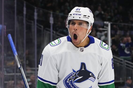 Vancouver Canucks center Dakota Joshua yells after scoring against the Seattle Kraken during the second period of an NHL hockey game Friday, Nov. 24, 2023, in Seattle. (AP Photo/Lindsey Wasson)
