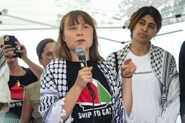Climate activist Greta Thunberg with other activists from a human rights organization meets with journalists in Catania, Italy, Sunday, June 1, 2025, ahead of their departure for the Mideast. (AP Photo/Salvatore Cavalli)