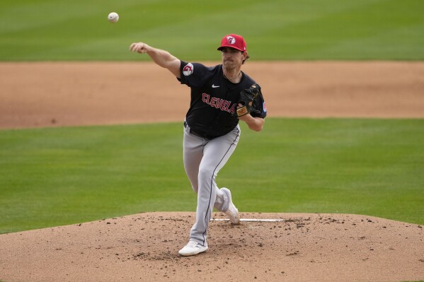 Cleveland Guardians pitcher Shane Bieber throws against the Oakland Athletics during the first inning of a spring training baseball game, Thursday, March 7, 2024, in Mesa, Ariz. (AP Photo/Matt York)