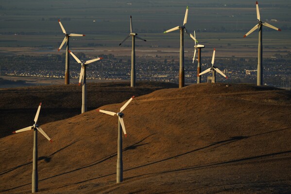 FILE - Wind turbines operate in Livermore, Calif., on Wednesday, Aug. 10, 2022. Biden, on his three-state western swing this past week, emphasized to donors and voters how the Inflation Reduction Act addresses climate change and promotes the creation of jobs as the economy moves toward renewable energy. (AP Photo/Godofredo A. Vásquez, File)