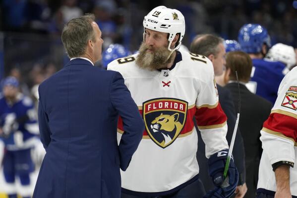 Florida Panthers center Joe Thornton (19) ongratulates Tampa Bay Lightning head coach Jon Cooper after the Lightning eliminated the Panthers during Game 4 of an NHL hockey second-round playoff series Monday, May 23, 2022, in Tampa, Fla. (AP Photo/Chris O'Meara)