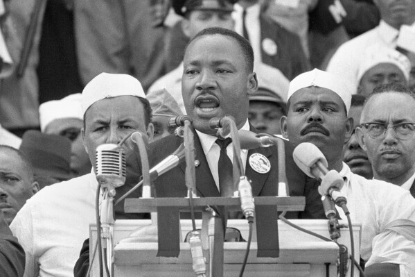 FILE - The Rev. Martin Luther King Jr., addresses marchers during his 