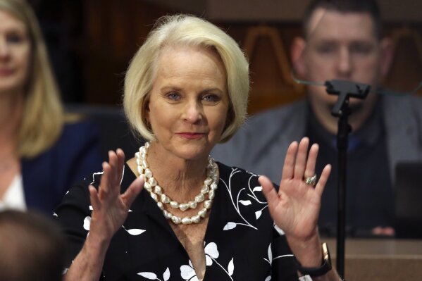 FILE - In this Jan. 13, 2020, file photo Cindy McCain, wife of former Arizona Sen. John McCain, waves to the crowd after being acknowledged by Arizona Republican Gov. Doug Ducey during his State of the State address on the opening day of the legislative session at the Capitol in Phoenix. Arizona Republicans voted Saturday, Jan. 23, 2021 to censure Cindy McCain and two prominent GOP officials who have found themselves crosswise with former President Donald Trump. (AP Photo/Ross D. Franklin, File)