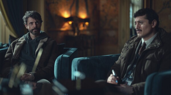 This image released by Netflix shows Matthew Goode, left, and Alexej Manvelov in a scene from the series "Dept. Q." (Netflix via AP)