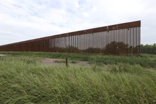 FILE - A border wall section stands on July 14, 2021, near La Grulla, Texas, in Starr County. On Wednesday, Oct. 4, 2023, the Biden administration announced that they waived 26 federal laws in South Texas to allow border wall construction, marking the administration’s first use of a sweeping executive power employed often during the Trump presidency. The Department of Homeland Security posted the announcement with few details outlining the construction in Starr County, Texas. (Delcia Lopez/The Monitor via AP, File)