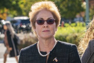 FILE - In this Oct. 11, 2019, file photo, former U.S. ambassador to Ukraine Marie Yovanovitch, arrives on Capitol Hill in Washington. The House impeachment panels are starting to release transcripts from their investigation. And in one of them, Yovanovitch says that Ukrainian officials warned her in advance that Rudy Giuliani and his allies were planning to "do things, including to me." (AP Photo/J. Scott Applewhite, File)