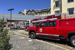 This photo provided by Aurora Fire Rescue shows firetrucks parked outside Gaylord Rockies resort on Saturday, May 6, 2023, in Aurora, Colo. Six people were hurt, two critically, when part of a heating and ventilation system collapsed at the resort pool in Colorado on Saturday, fire officials said. (Aurora Fire Rescue via AP)