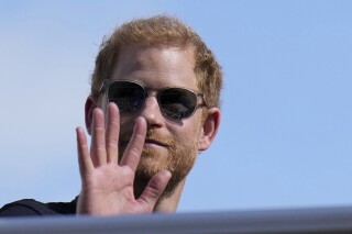 FILE - Britain's Prince Harry, The Duke of Sussex, waves during the Formula One U.S. Grand Prix auto race at Circuit of the Americas, on Oct. 22, 2023, in Austin, Texas. Prince Harry dropped his libel lawsuit Friday Jan. 19, 2024 against the publisher of the Daily Mail tabloid following a ruling in which a judge cast doubt on his case. (AP Photo/Nick Didlick, File)