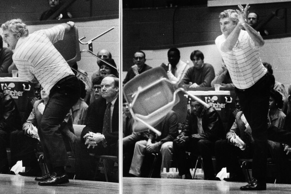 ADDS NAME OF PHOTOGRAPHER - FILE - This Feb. 23, 1985, file photo shows Indiana coach Bob Knight winding up and pitching a chair across the floor during Indiana's 72-63 loss to Purdue, in Bloomington, Ind. Bob Knight, the brilliant and combustible coach who won three NCAA titles at Indiana and for years was the scowling face of college basketball has died. He was 83. Knight's family made the announcement on social media Wednesday evening, Nov. 1, 2023. (AP Photo/Angela Gottschalk, File)