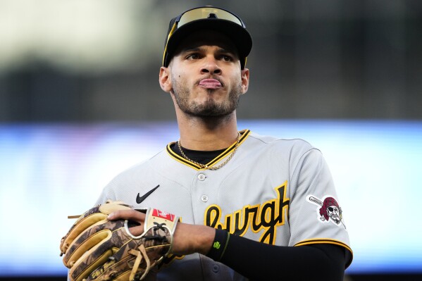 FILE - Pittsburgh Pirates' Tucupita Marcano jogs off the field against the Seattle Mariners in a baseball game, Friday, May 26, 2023, in Seattle. Major League Baseball has permanently banned Marcano Tuesday, June 4, 2024, for betting on baseball and suspended the four other players for one year after finding the players placed unrelated bets with a legal sportsbook. (AP Photo/Lindsey Wasson, File)